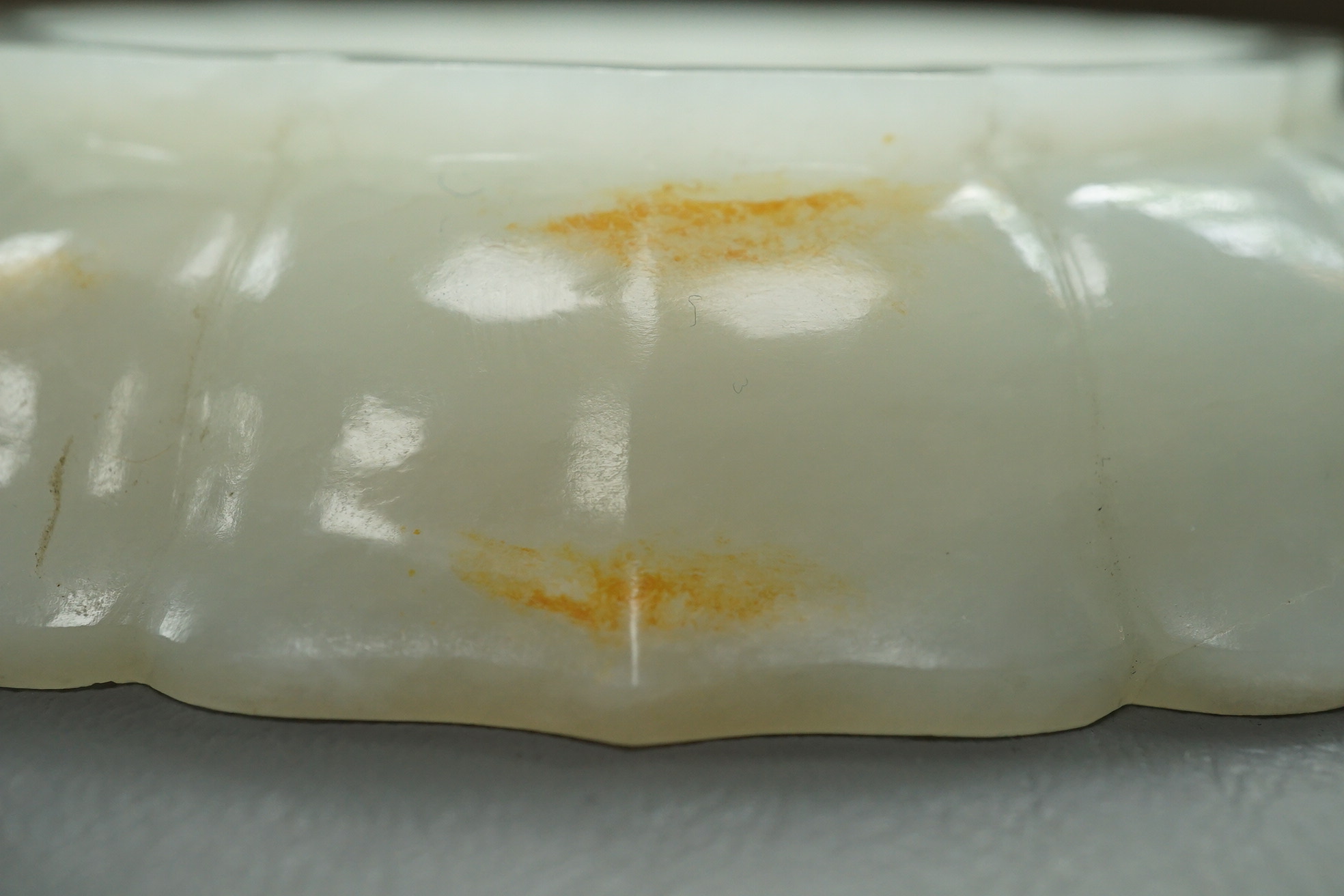 A Chinese white and russet jade petal lobed cup stand